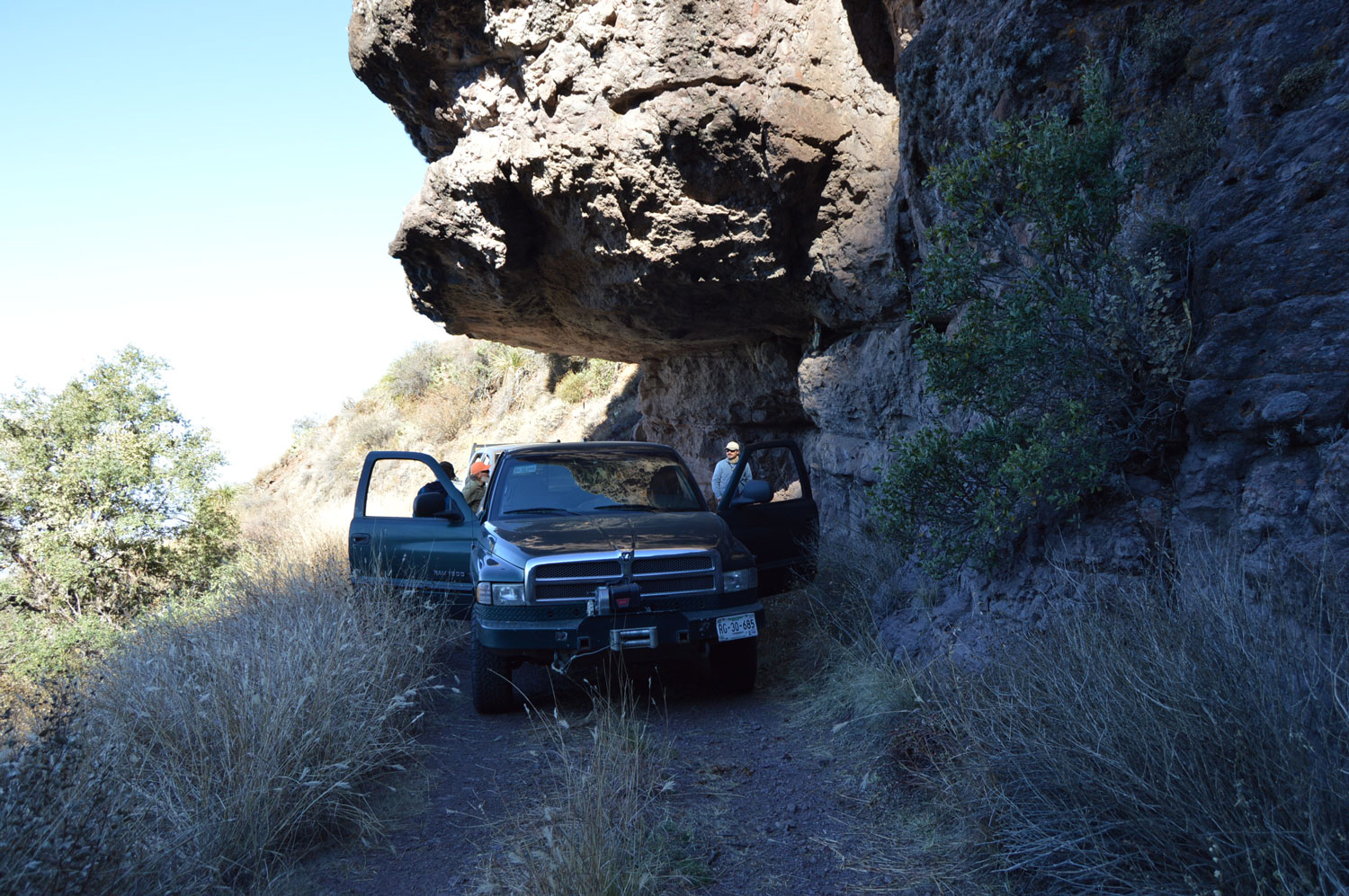 Guide truck parked beneath a rock overhang
