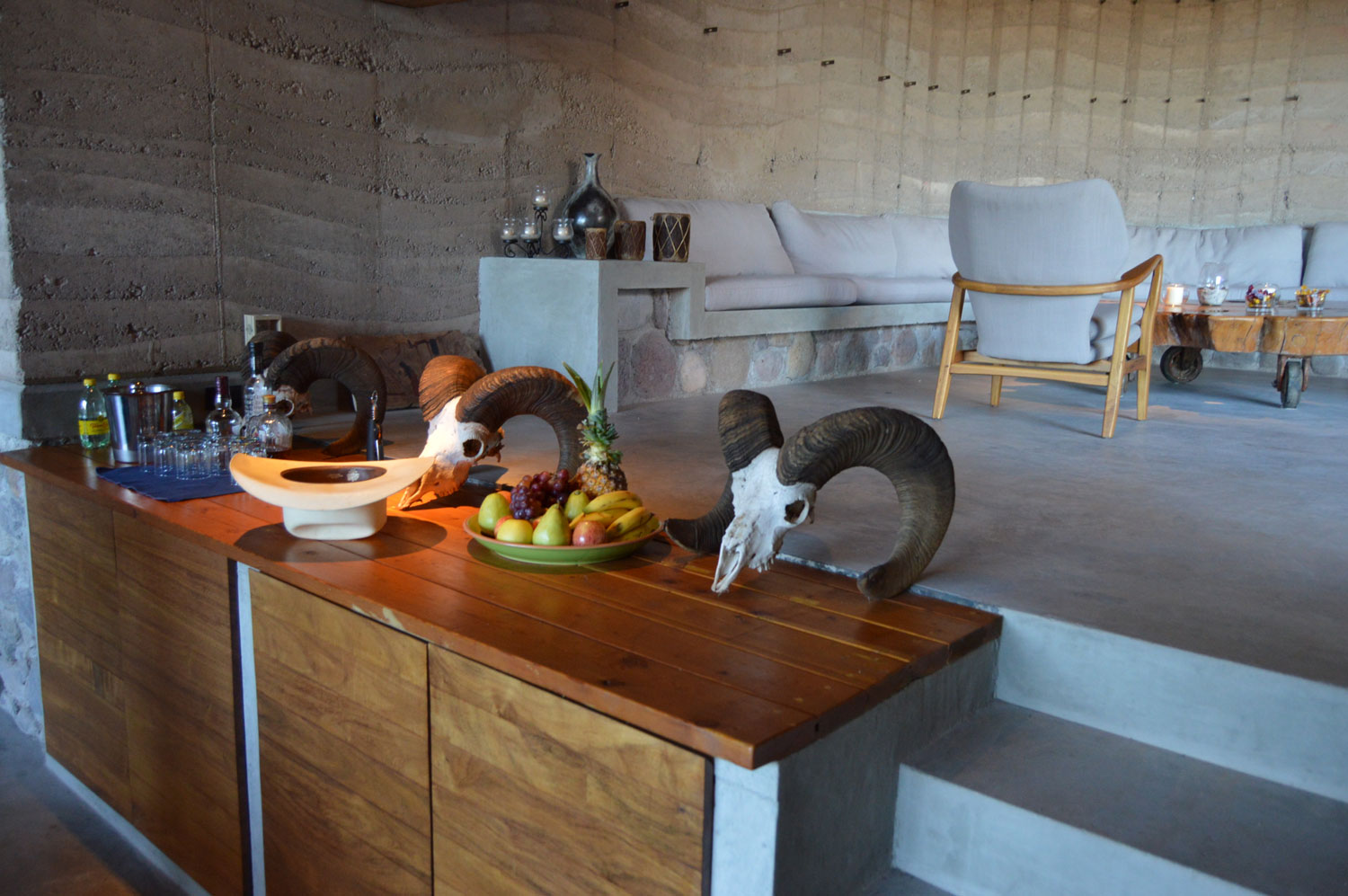 Rustic seating area and service counter in La Cueva with ram's skulls, fruit and cowboy hat
