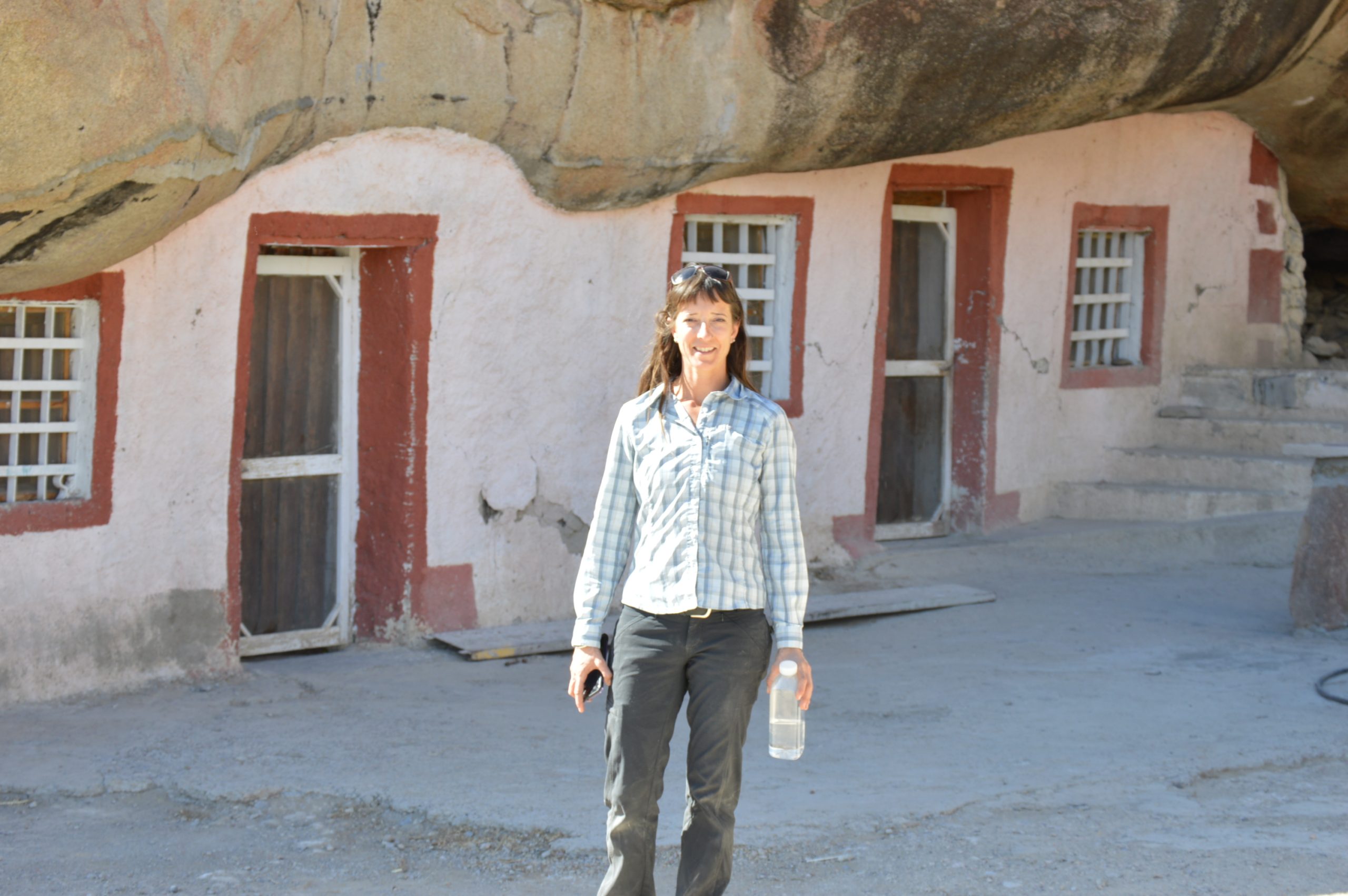 Woman standing in front of Casa Piedra, near Boquillas, Mexico.